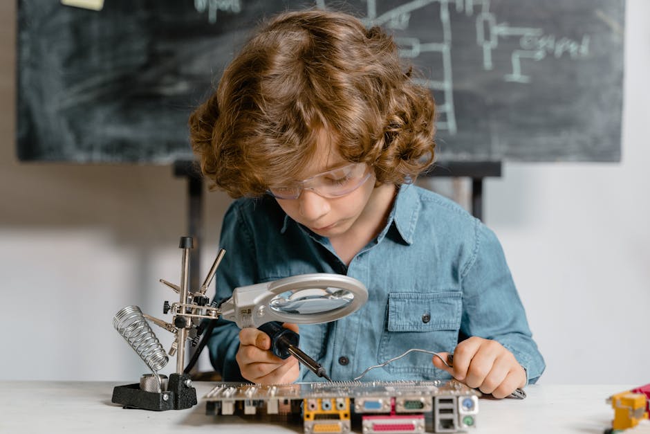 Young boy diligently working on a circuit board, exploring science and technology.